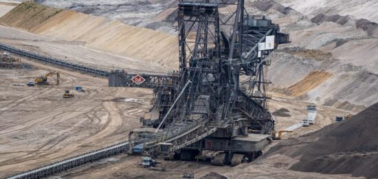 a large machine is in the middle of a quarry